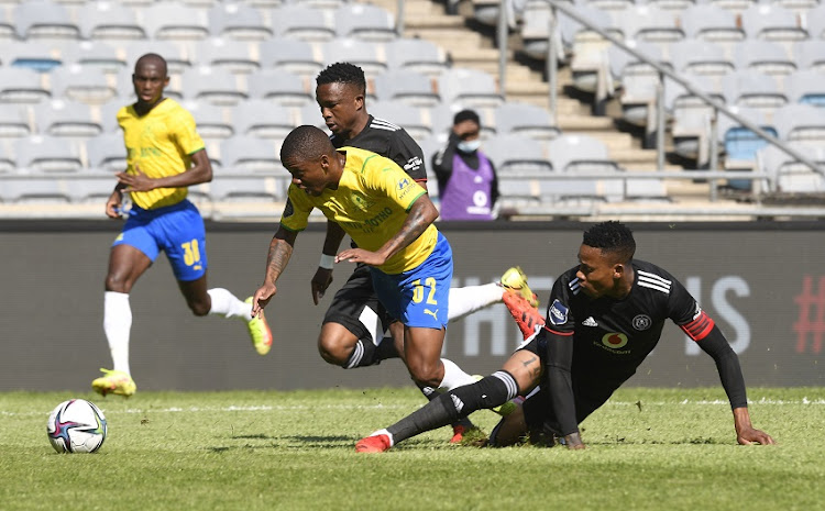 Happy Jele of Orlando Pirates challenges Thabiso Kutumela of Mamelodi Sundowns during the DStv Premiership match between Orlando Pirates and Mamelodi Sundowns at Orlando Stadium on September 25, 2021 in Johannesburg, South Africa.