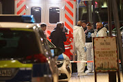 Forensic experts are seen outside a shisha bar after a shooting in Hanau near Frankfurt, Germany, February 20, 2020. 