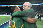 Springbok player Damian Willemse celebrates his side's victory with coach Jacques Nienaber after the match against England at Twickenham Stadium on November 26, 2022 in London.