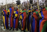 The seven initiates from this village proudly display their new 'Middelburg blankets' and their sticks, which signify that they are now men. Despite it being the middle of winter, they are barefoot.