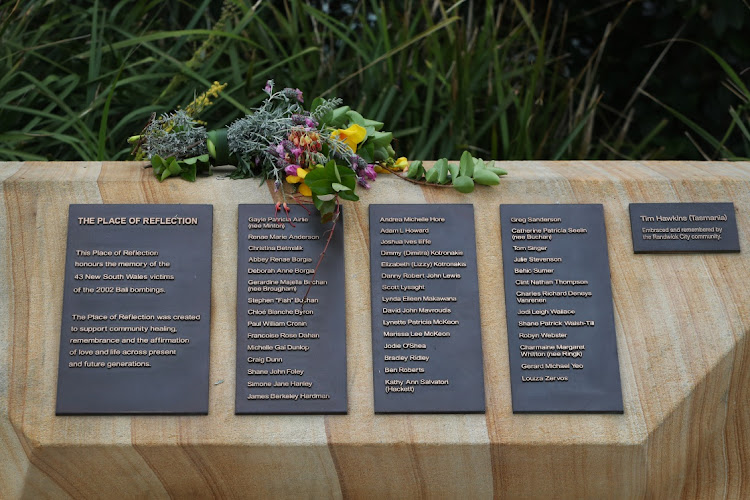 Flowers are seen on a memorial plaque at Dolphins Point, Coogee Beach on October 12, 2022 in Sydney, Australia. The 2002 Bali bombings claimed 202 lives, including 88 Australians, with many more wounded. Three bombs were detonated in busy Bali night spots the Sari Club and Paddy's Bar in Kuta at 11pm on 12 October 2002 by the terrorist organisation Jemaah Islamiyah. The attacks represent the single largest loss of Australian life due to an act of terror.