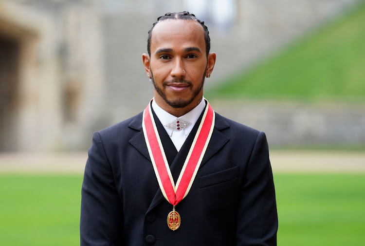 Sir Lewis Hamilton after he was made a knight bachelor by the Prince of Wales during a investiture ceremony at Windsor Castle on December 15 2021 in Windsor, England.