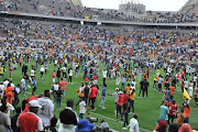 Orlando Pirates fans storm the pitch after their team's 3-0 MTN8 semifinal second leg victory against Mamelodi Sundowns at Peter Mokaba Stadium in Polokwane on October 22 2022.