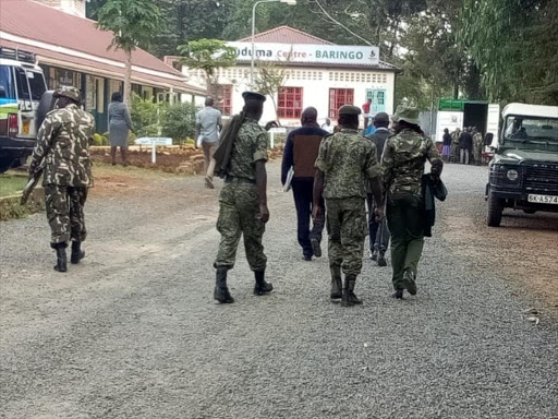 Security officers escort KCPE papers from Kabarnet town, Baringo Central Sub-county on Tuesday./JOSEPH KANGOGO