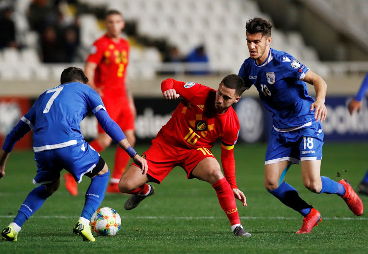 Belgium's Eden Hazard in action with Cyprus' Kostakis Artymatas and Georgios Efrem