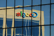 The Google logo is shown reflected on an adjacent office building in Irvine, California.