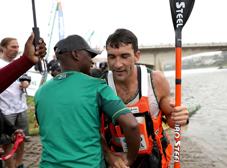 KZN MEC for sport, arts and culture Dr Ntuthuko Mahlaba congratulates Andy Birkett on his win in the 2024 Dusi canoe marathon.