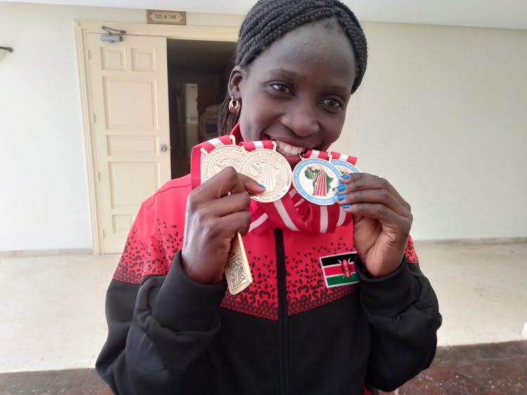 Florence Wasike shows off her medals after winning triple at the Africa Masters Athletics championships in Tunisia. She is one of the athletes expected to compete at the trials in the 35-39 years category