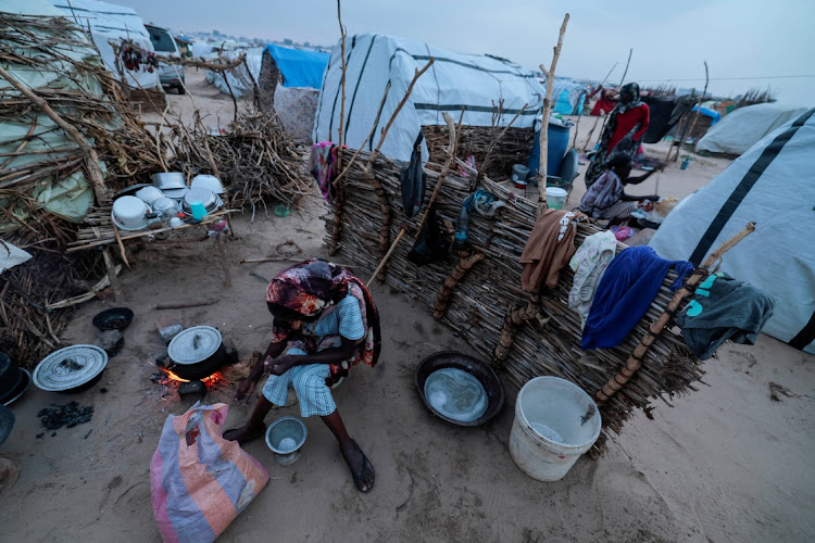 Sudanese women who fled the conflict in Sudan's Darfur region cook at their makeshift shelters in Adre, Chad, on August 3 2023. File photo.