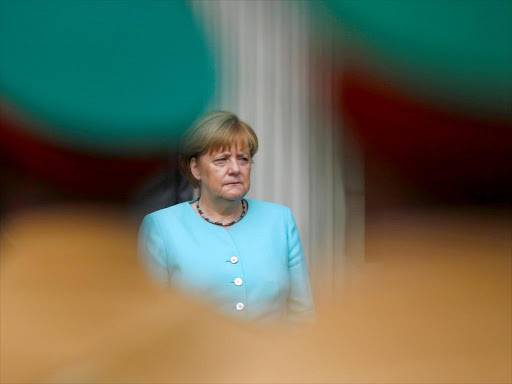 German Chancellor Angela Merkel listens to the national anthems at the National Palace in Ethiopia's capital Addis Ababa October 11, 2016. /REUTERS