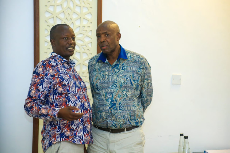 National Assembly education committee chairman Julius Melly and Education CS Ezekiel Machogu at Pride Inn Paradise Hotel in Mombasa on Thursday