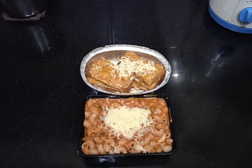 Macaroni Pasta In Pink Sauce Along With Cheese Garlic Bread