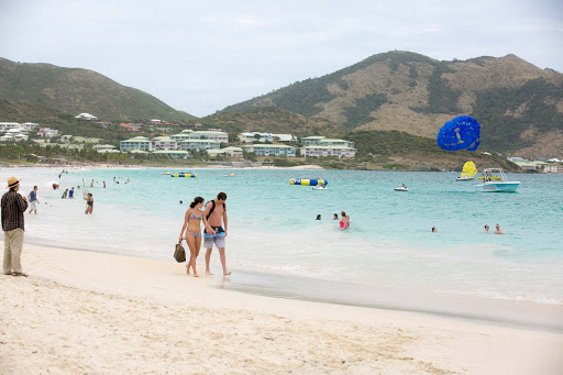 orient-bay-redone.jpg - Strolling the long sweep of beaches at Orient Bay, where French and English are widely spoken.