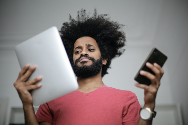 Man looks at different digital devices