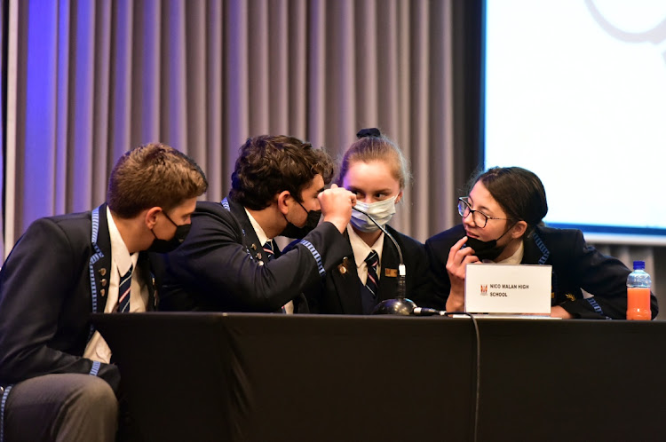 Nico Malan High’s Jano Bezuidenhout, Dewaldt Koen, Juane Oosthuizen and Mariche Watermeyer confer during the quarterfinals of the Herald Isuzu Schools Quiz at the Radisson Blu Hotel.