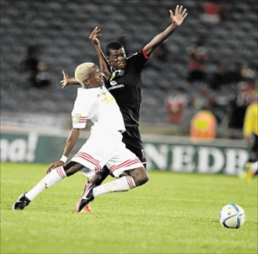 FULL FLIGHT: Pirates' Sifiso Myeni, right, and Denklan Ngwetjana of Tornado do battle during the Nedbank Cup first round match at Orlando Stadium, Soweto, last night. Pirates romped to an easy 4-0 win Photo: Lefty Shivambu/ Gallo Images