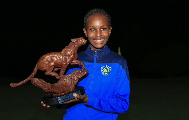 Gitau Mumbi posses with her trophy after being crowned overall winner at the Limuru Country Club on September 4, 2021