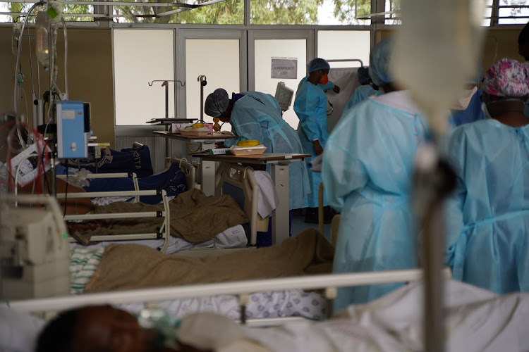 Doctor's and nurses at Tembisa hospital work their rounds in one of the Covid dedicated wards.