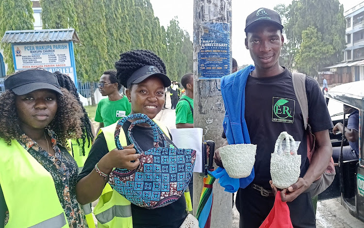 Eco-Redemptors' Philomena Muthoni [C] and Francis Aute [R] showcase their baskets made of plastic yarn.