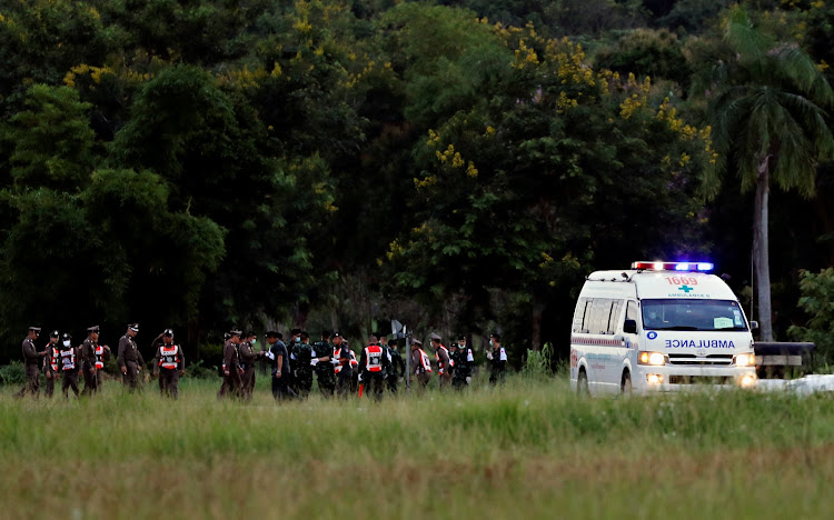 An ambulance carrying rescued schoolboys that were trapped in a cave leaves a military airport in Chiang Rai, Thailand, July 10, 2018.