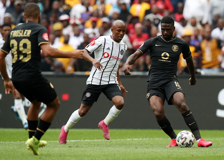 Kgotso Moleko of Kaizer Chiefs clears ball from Luvuyo Memela of Orlando Pirates during the Absa Premiership 2019/20 match between Orlando Pirates and Kaizer Chiefs at the FNB Stadium, Soweto on the 29 February 2020.