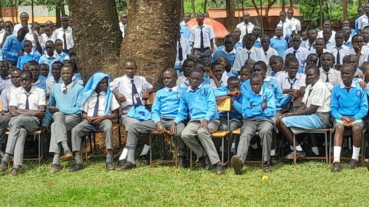 Students from various schools from Gem Constituency on Monday wait to receive cheques for bursaries awarded to them by Siaya County government at Lundha mixed secondary school in North Gem on Monday.