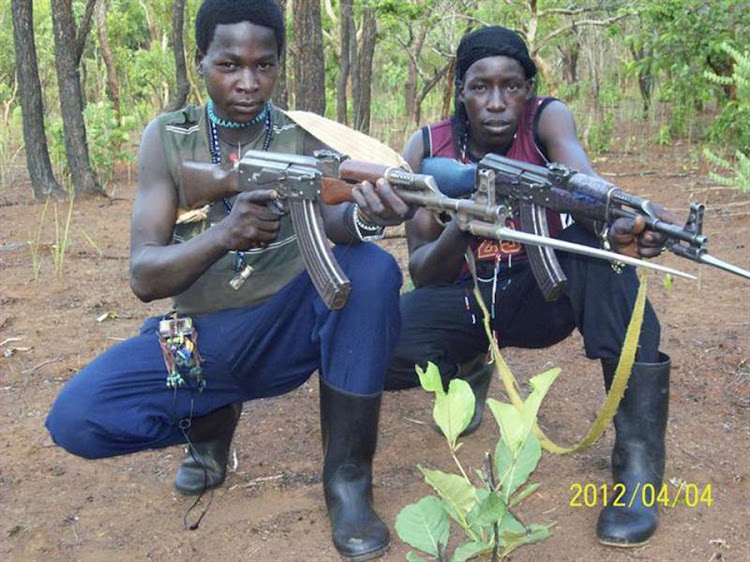 Fighters loyal to the Lord's Resistance Army pose with their rifles in Central African Republic. Picture: REUTERS