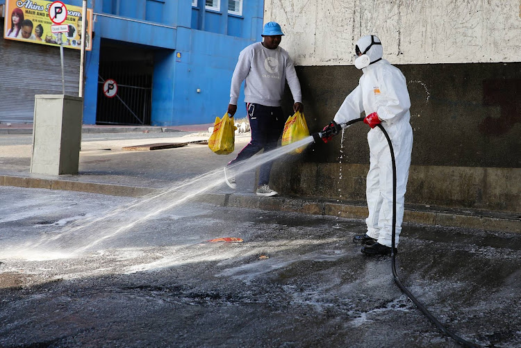 Workers from Xtreme Projects disinfect and clean the Strand Street taxi rank and surrounding area on April 7. Xtreme Projects owner Kevin Kelly decided to do his bit to curb the spread of the Covid-19 virus by using his company to disinfect the area