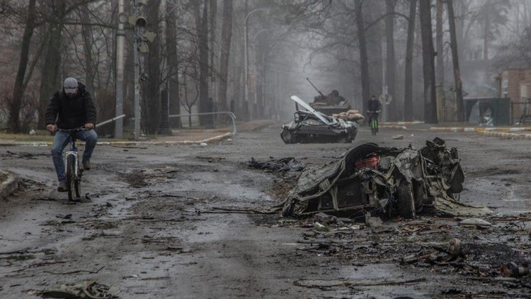 Flattened civilian cars on the streets of Bucha