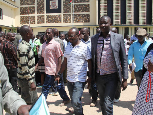 Candidate Silas Jakakimba (white) leaves the Homa Bay county assembly building after the botched nominations./HABIL ONYANGO