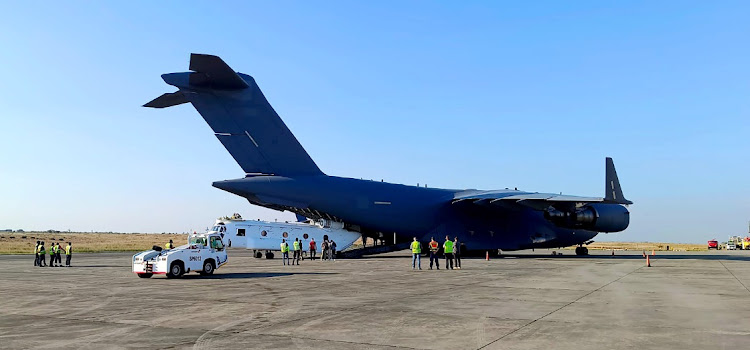 A cargo plane offloads cars belonging to UAE president Sheikh Mohamed bin Zayed al Nahyan at Bhisho Airport in the Eastern Cape.