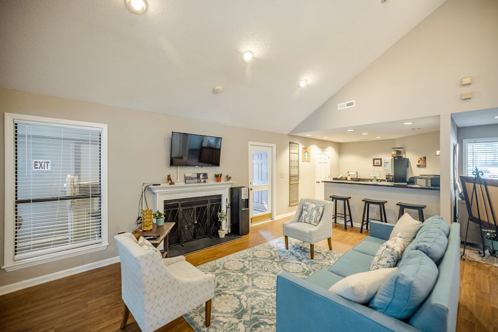 Clubhouse lounge area with seating, a TV, and fireplace