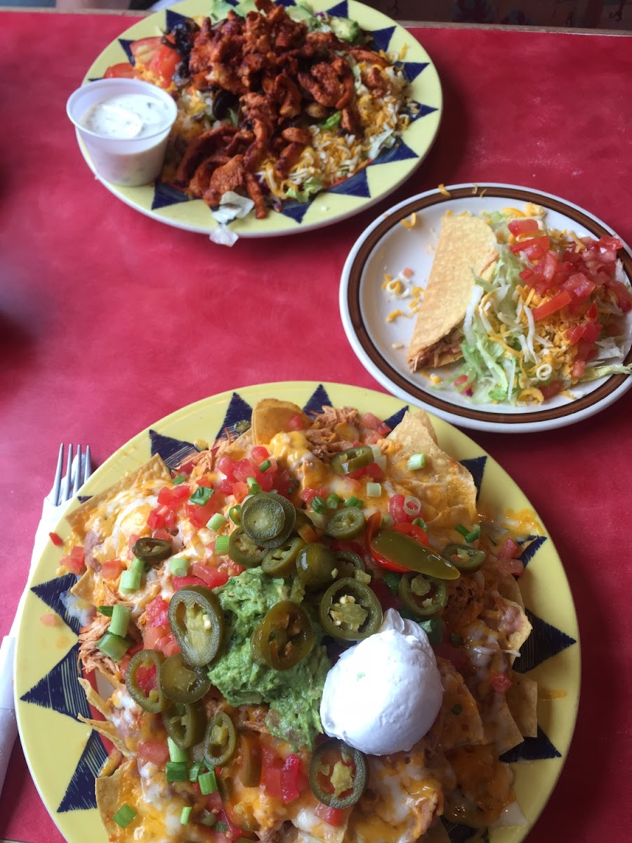 Super nachos, one taco, and fajita salad in background