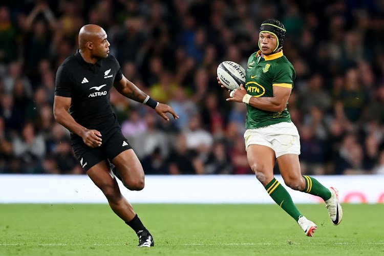 Springbok winger Kurt-Lee Arendse makes a break ahead of Mark Telea of New Zealand during their World Cup warm-up match at Twickenham Stadium on August 25, 2023 in London, England.