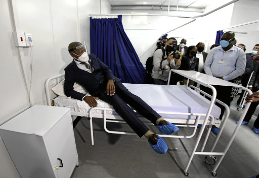 Health minister Zweli Mkhize tests a mattress in one of the newly built Covid-19 wards at Clairwood Hospital in Durban. Mkhize visited urban and rural hospitals in KwaZulu-Natal to check the state of readiness as the pandemic approaches its expected peak in the province.