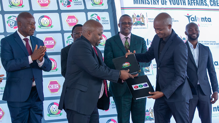 KBC MD Samuel Maina exchanges signed documents during KBC's announcement as the official free to air partner on November 30, 2023/ CHARLENE MALWA