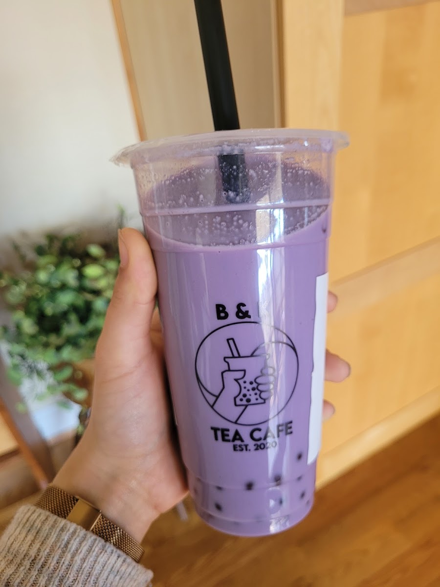 Taro milk tea with almond milk and strawberry poppers.