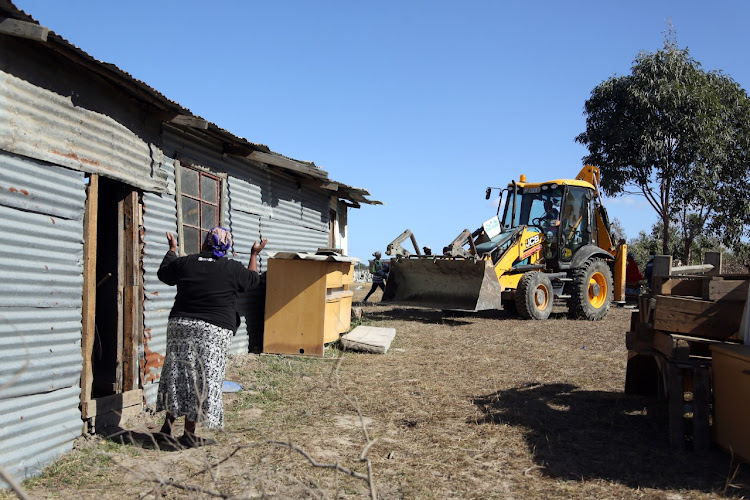 Illegal buildings being demolished outside East London. Scores of families were evicted from their illegal homes built on the state-owned Greydell farm near the East London Airport.