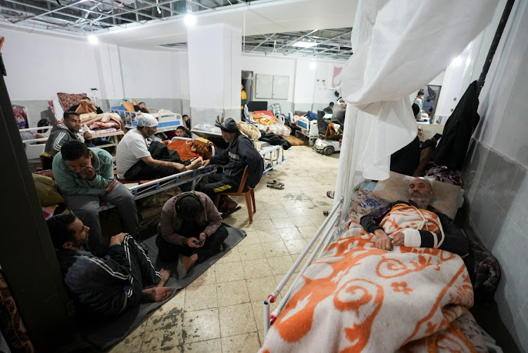 Palestinians wounded in Israeli strikes lie on beds as displaced people shelter at Shuhada Al-Aqsa Hospital in Gaza. South Africa has accused Israel of genocide. File photo.