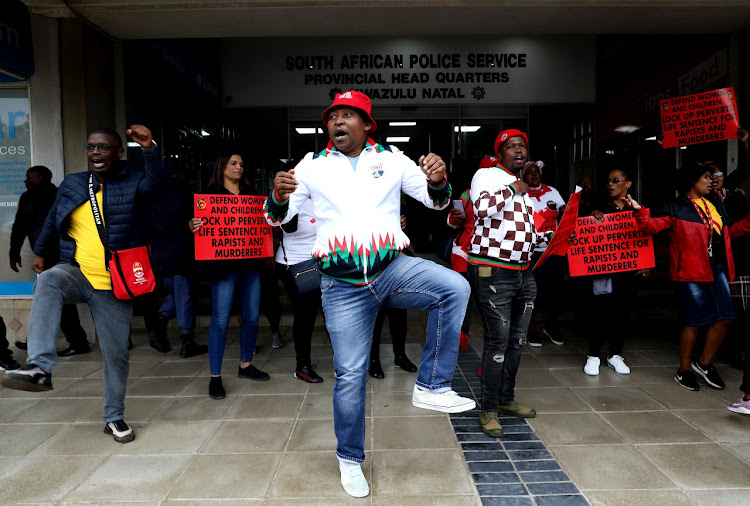 Cosatu members picket outside the SAPS headquarters in Durban on Friday.