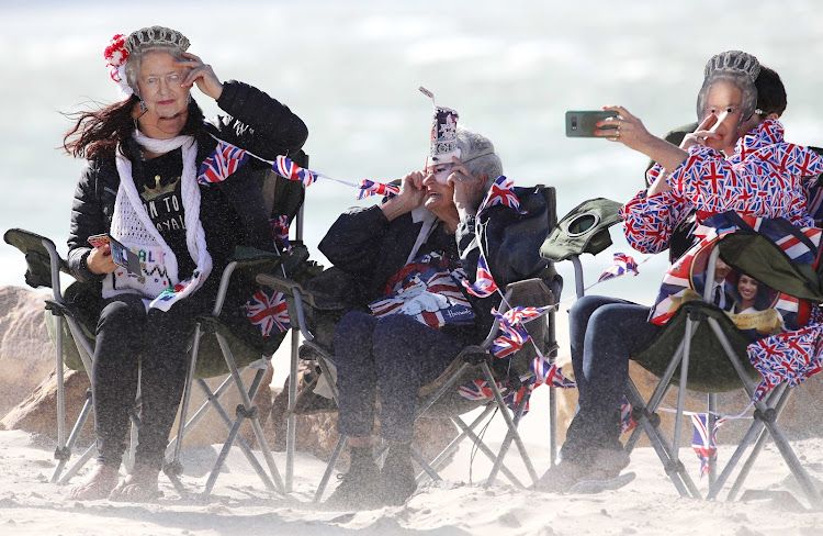 Wendy Perks and her daughters, Jenny and Carol, await the arrival of the Duke and Duchess of Sussex at Monwabisi Beach on September 24 2019 in Cape Town.