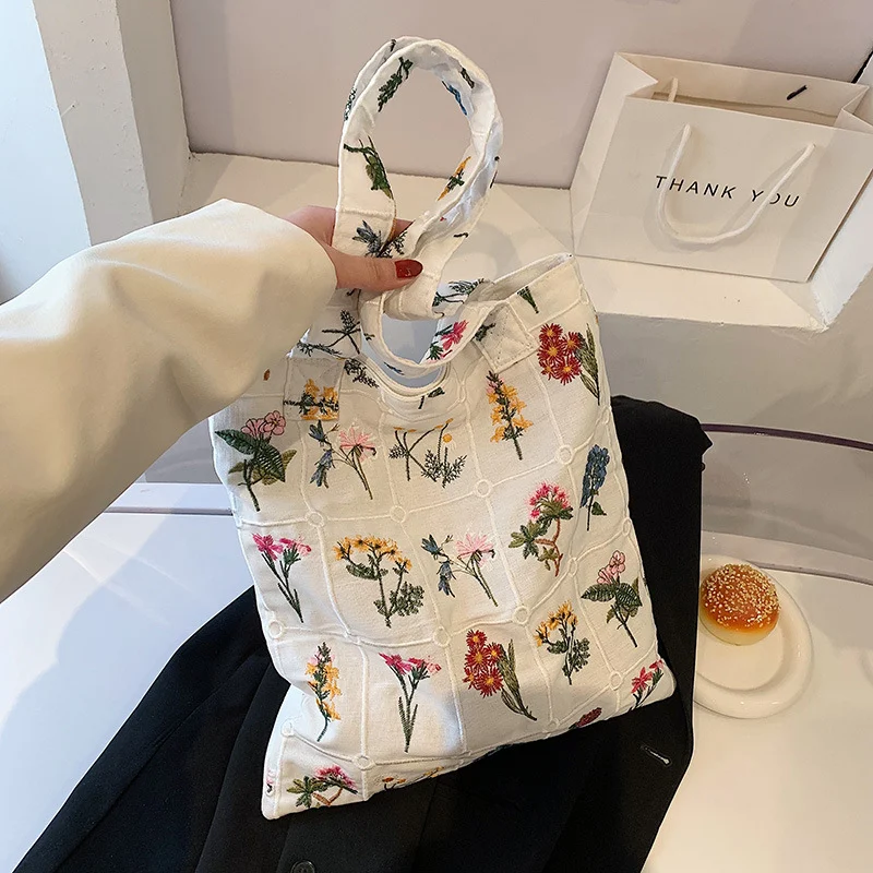 Bolsa de ombro feminina simples com bordado, um acessório de moda elegante e prático. Ideal para carregar seus itens essenciais com estilo e conforto.