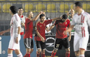 CAPTAIN COURAGEOUS:  Mohamed Aboutrika of Egypt's Al-Ahly, 2nd right,  celebrates with teammates after scoring his goal against Egypt's Zamalek during their CAF Champions League soccer match at the Military Stadium in Cairo. PHOTO: REUTERS