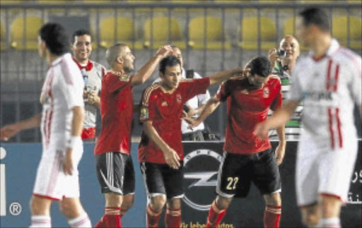 CAPTAIN COURAGEOUS: Mohamed Aboutrika of Egypt's Al-Ahly, 2nd right, celebrates with teammates after scoring his goal against Egypt's Zamalek during their CAF Champions League soccer match at the Military Stadium in Cairo. PHOTO: REUTERS