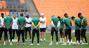 Bafana Bafana players and coach Hugo Broos pray before their training session at FNB Stadium on Monday.
