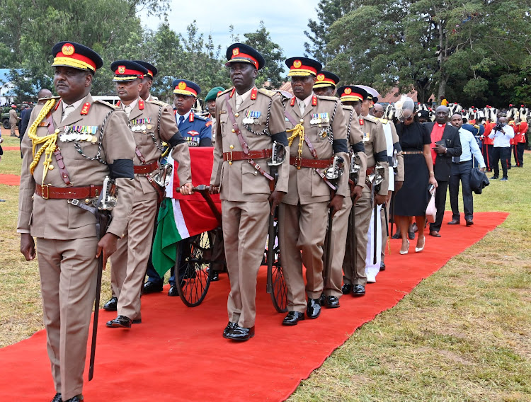 Kenya Defence Forces (KDF) officers carrying the body of CDF General Francis Ogolla during the burial ceremony at his home at Ngiya Village in Siaya County on April 21, 2024.