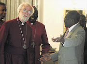 Zimbabwe's President Robert Mugabe welcomes the Archbishop of Canterbury, Rowan Williams, for a meeting at the State House in Harare yesterday Picture: PHILIMON BULAWAYO/REUTERS