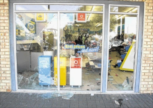 SHATTERED: A broken window and strewn debris are evidence of a violent service delivery protest in Zandspruit near Honeydew yesterday where residents vandalised a Pep store. PHOTO: SIBUSISO MSIBI