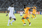 FIGHT TO THE END: Asamoah Gyan of the Black Stars vies for the ball with Siaka Tiene of Ivory Coast during the tense Africa Cup of Nations final match in Bata, Equatorial Guinea, last night. Ivory Coast won after a nerve-wracking penalty shootout