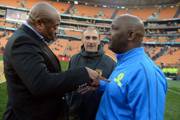 Kaizer Chiefs football manager Bobby Motaung (L) congratulates Mamelodi Sundowns head coach Pitso Mosimane (R) as his Amakhosi counterpart Giovanni Solinas looks on after the Shell Helix Ultra Cup pre-season friendly match on July 21 2018 at FNB Stadium. Sundowns won 2-1 to lift the Cup.